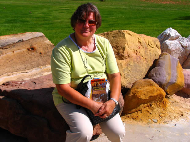 Maria, my wife sitting on very colorful rocks of the Rocky Mountains. 